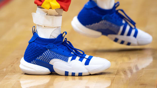 View of Trae Young's blue and white adidas shoes.